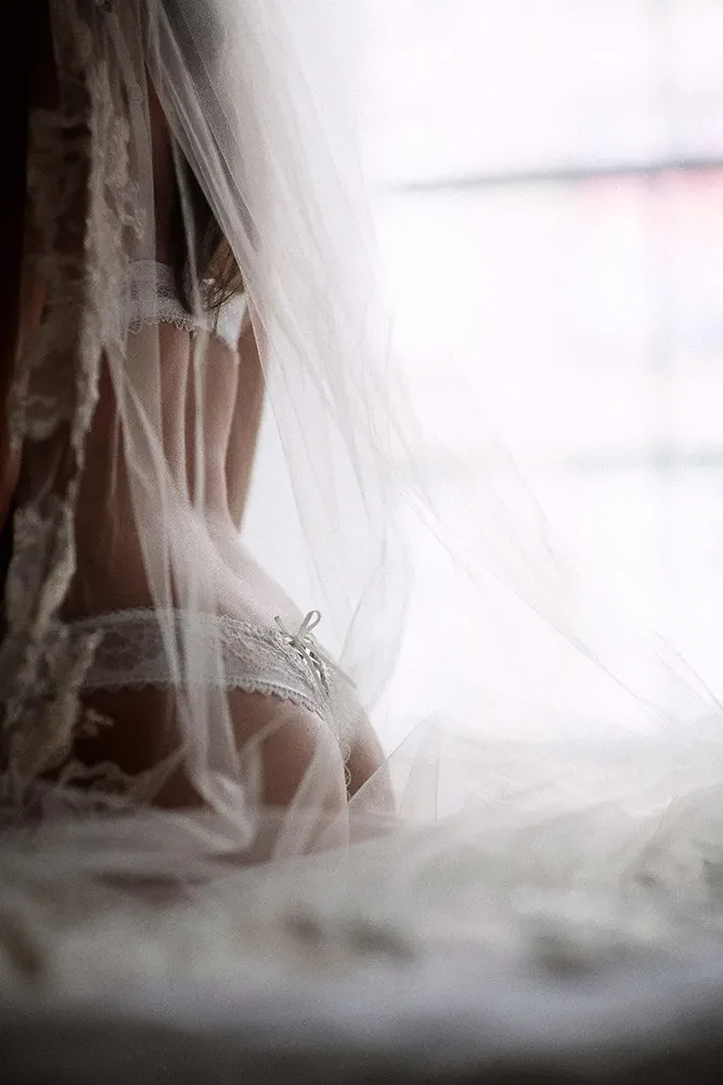 Portret bridal boudoir – mireasă în lenjerie albă și voal lung, lumină difuză