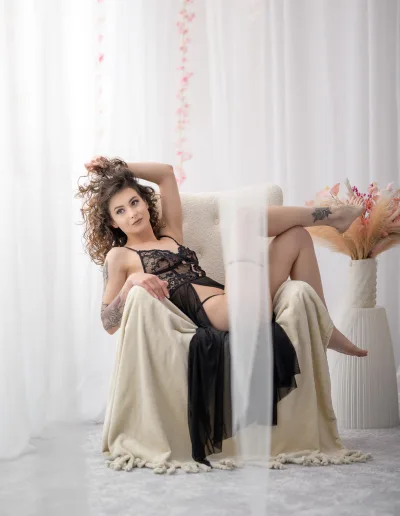 poze boudoir Bucuresti model asezat relaxat pe fotoliu cu decor boho alb